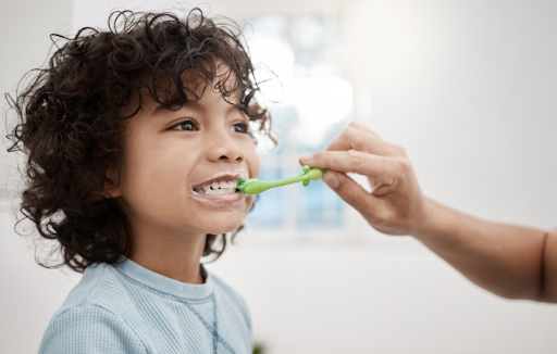 A child being tooth brushed